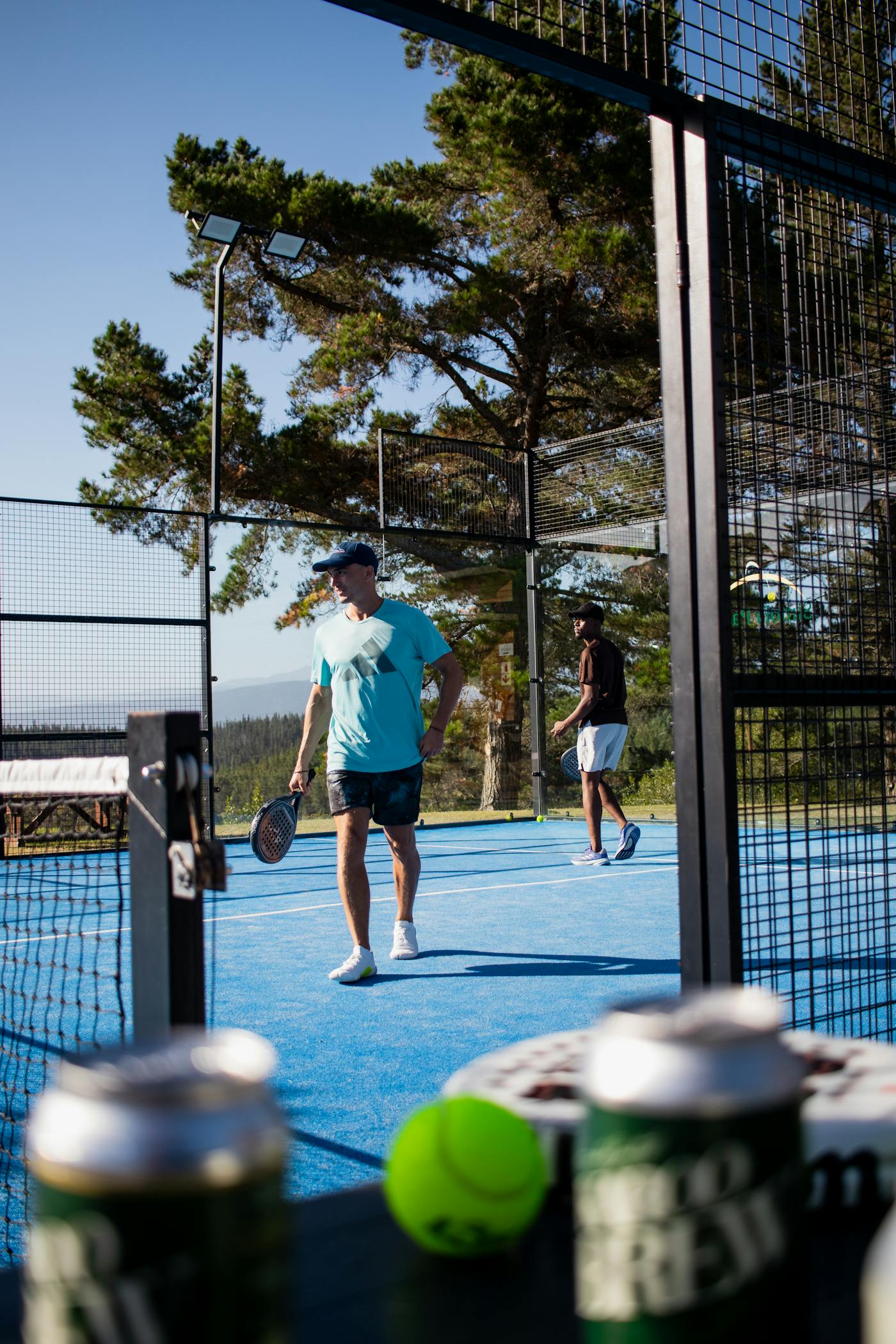 Two men playing padel on an outdoor court