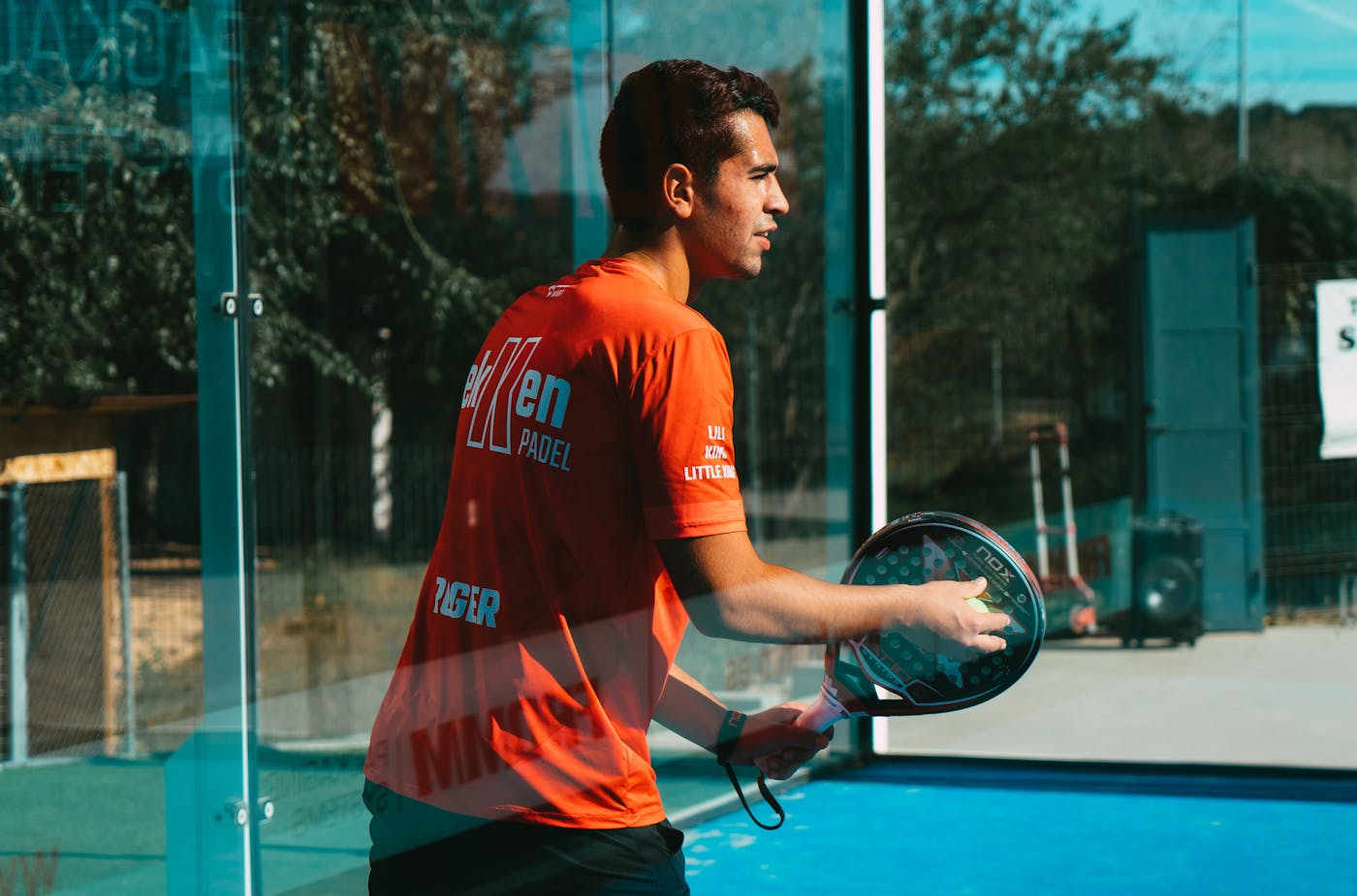 Male padel player preparing on a padel court