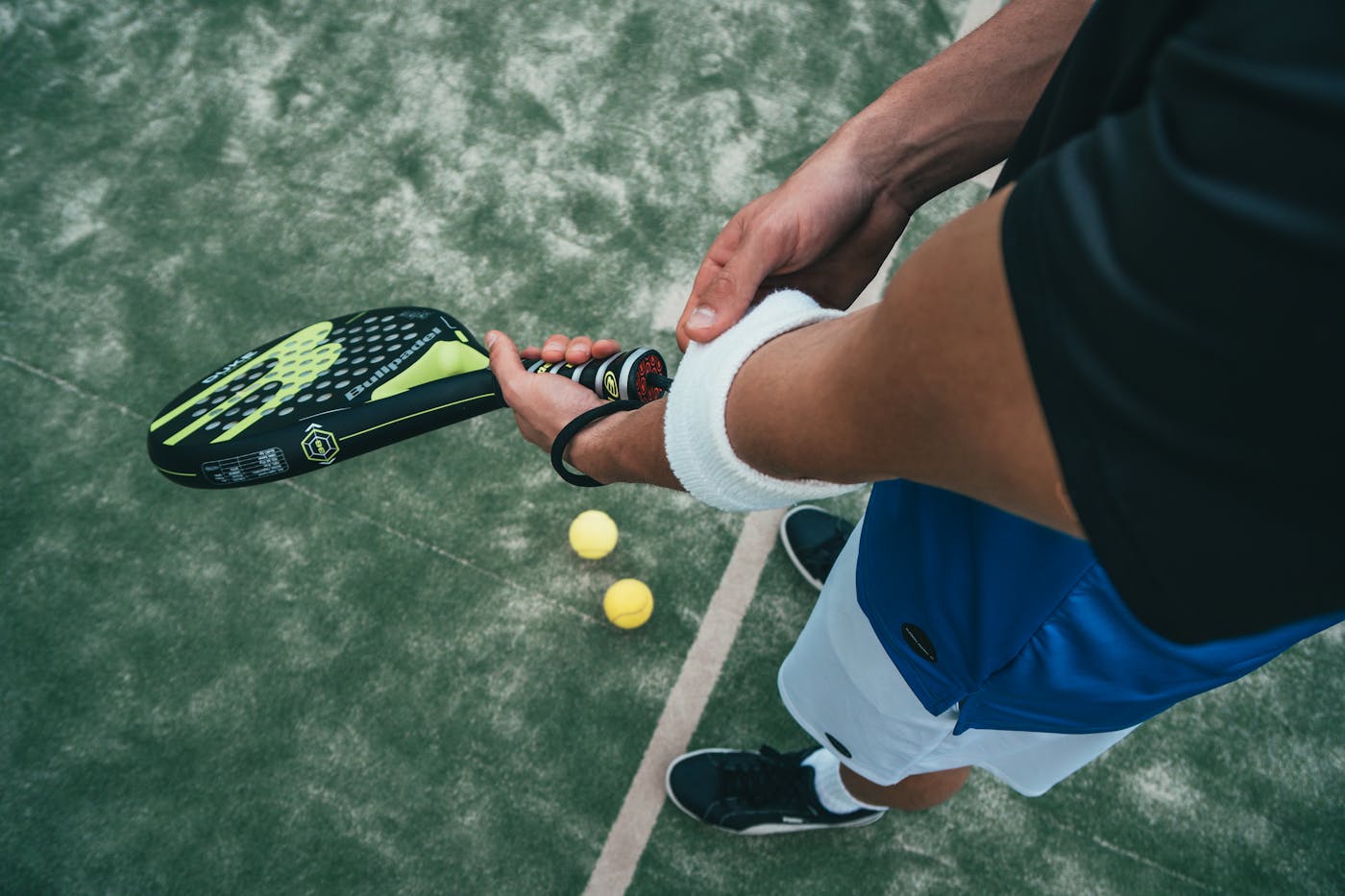 Padel racket and balls on a court